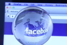 Facebook webpage with glass globe. As of today, Facebook is the largest social media network on the web